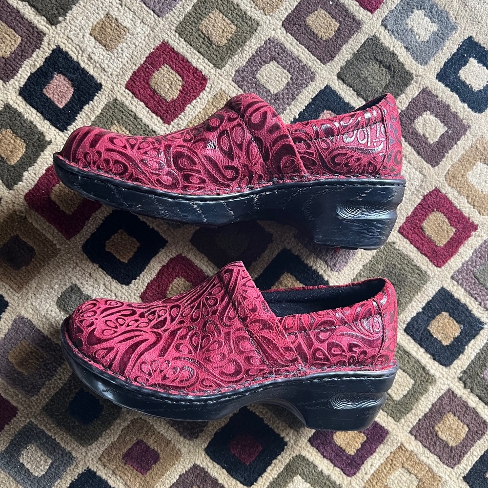Scroll design red leather slip on clogs. Boc Born Concept
